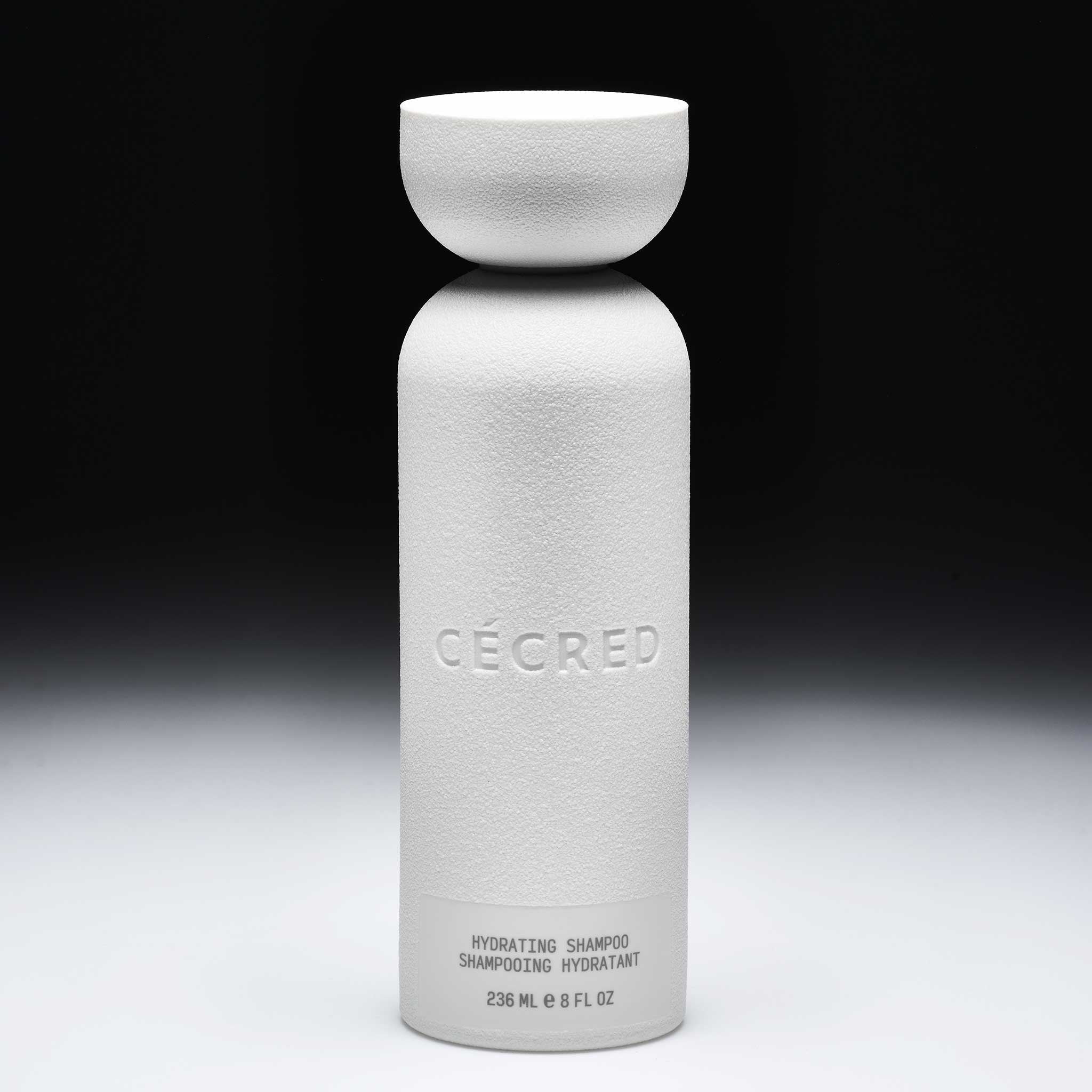 Cécred Hydrating Shampoo bottle displayed upright on a gradient black-to-white background.