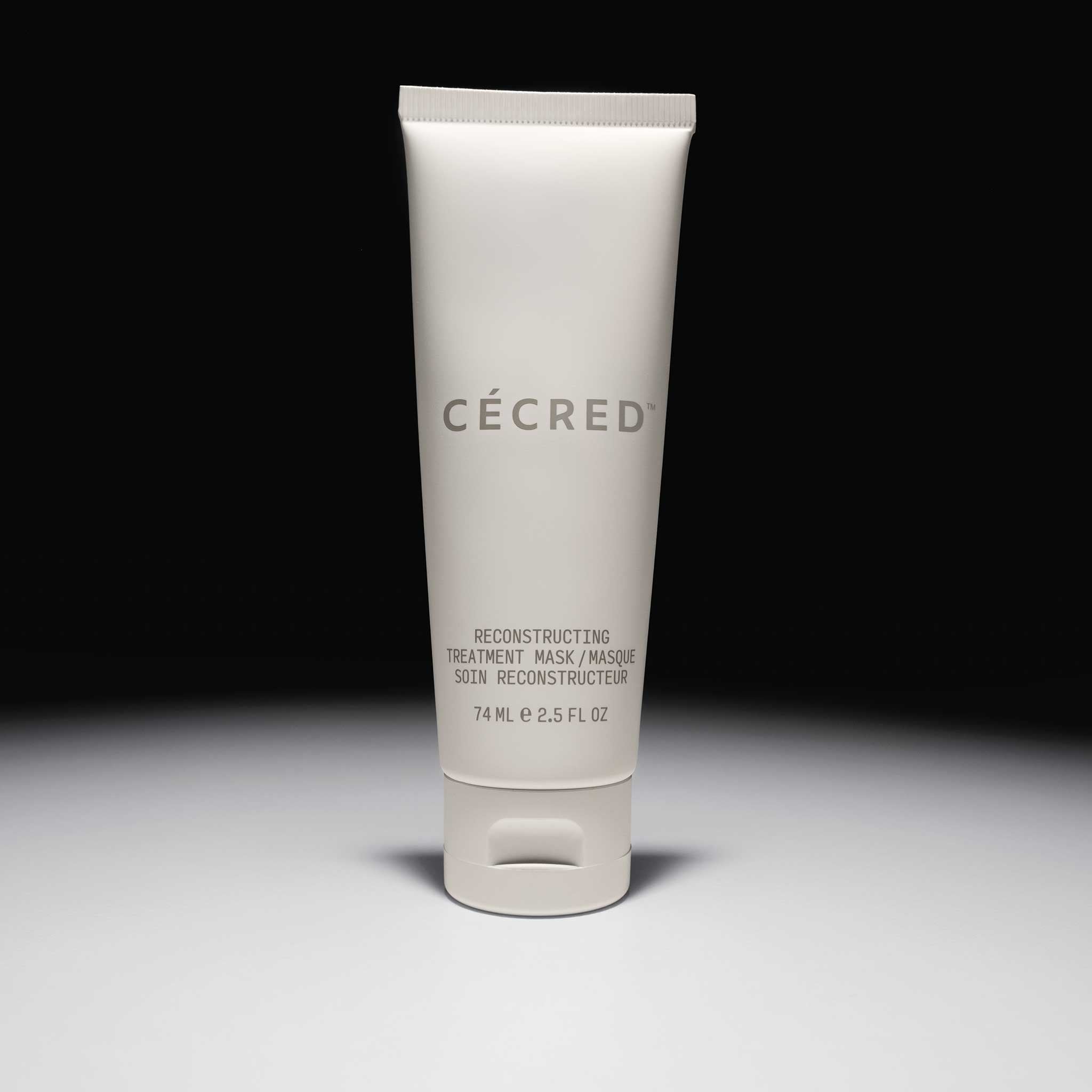 Cécred Reconstructing Treatment Mask travel tube, standing on gradient surface with soft lighting.