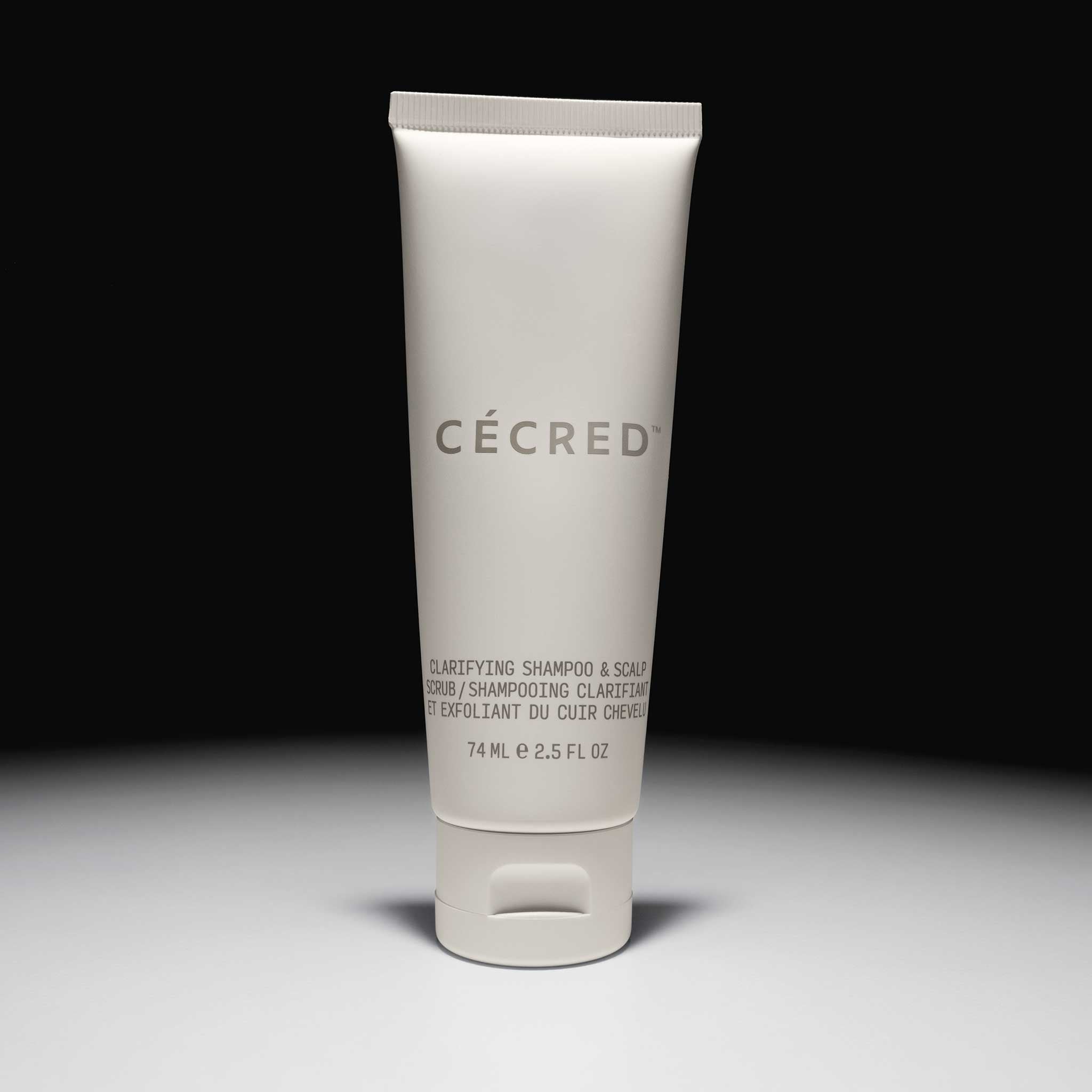 Cécred Clarifying Shampoo & Scalp Scrub travel tube spotlighted with matte finish and product name in focus.