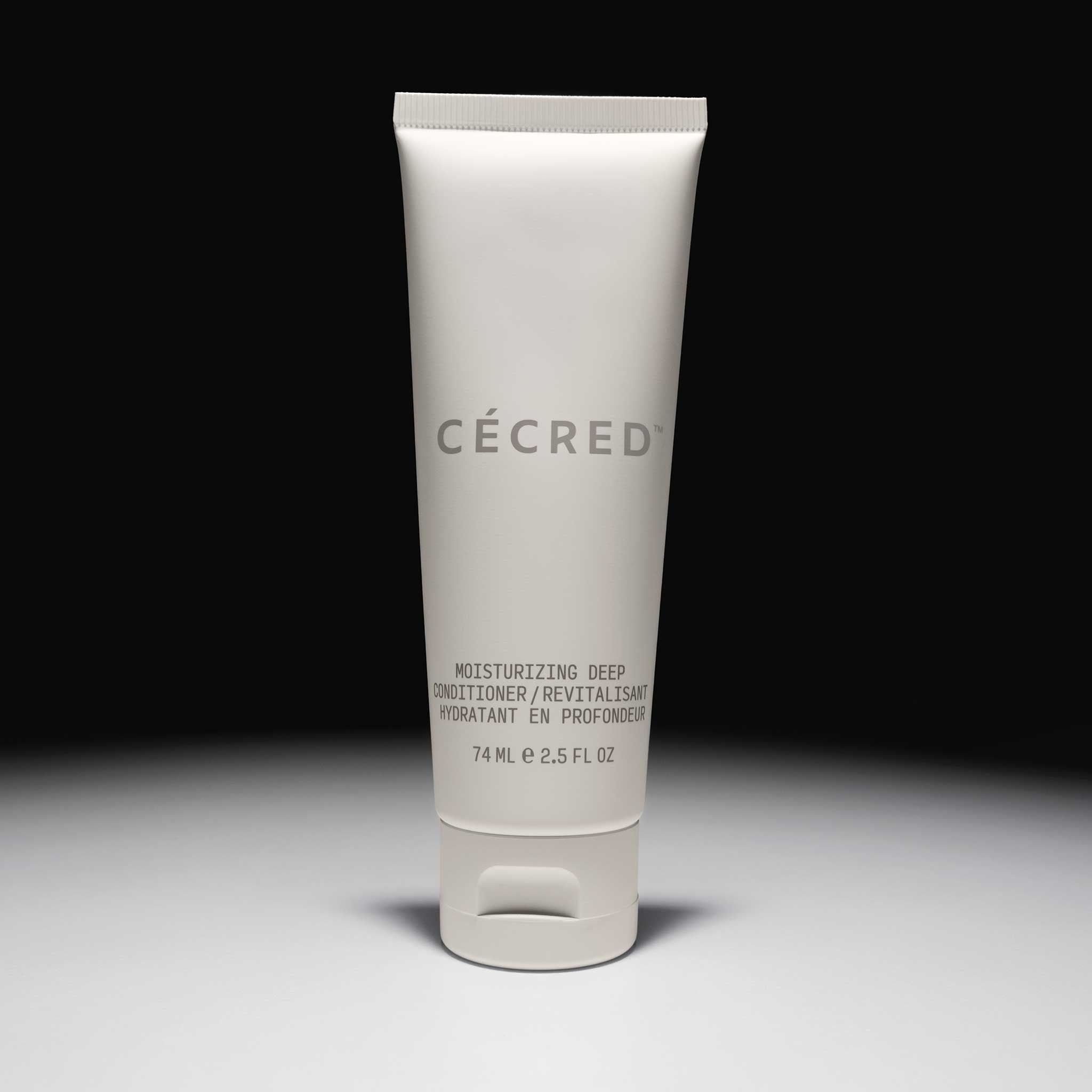 Cécred Moisturizing Deep Conditioner travel tube displayed on spotlight background.