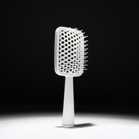 Cécred Detangling Brush shown in full to highlight its sleek design and signature wide, flexible bristles.