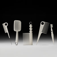 Set of hair styling tools including combs and a brush on a gradient background