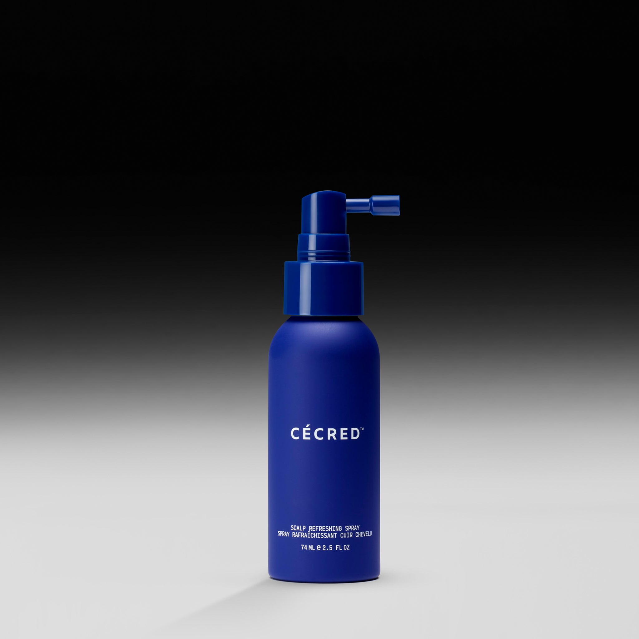 Dark blue spray bottle with pump nozzle and white 