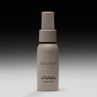 Beige spray bottle labeled 
