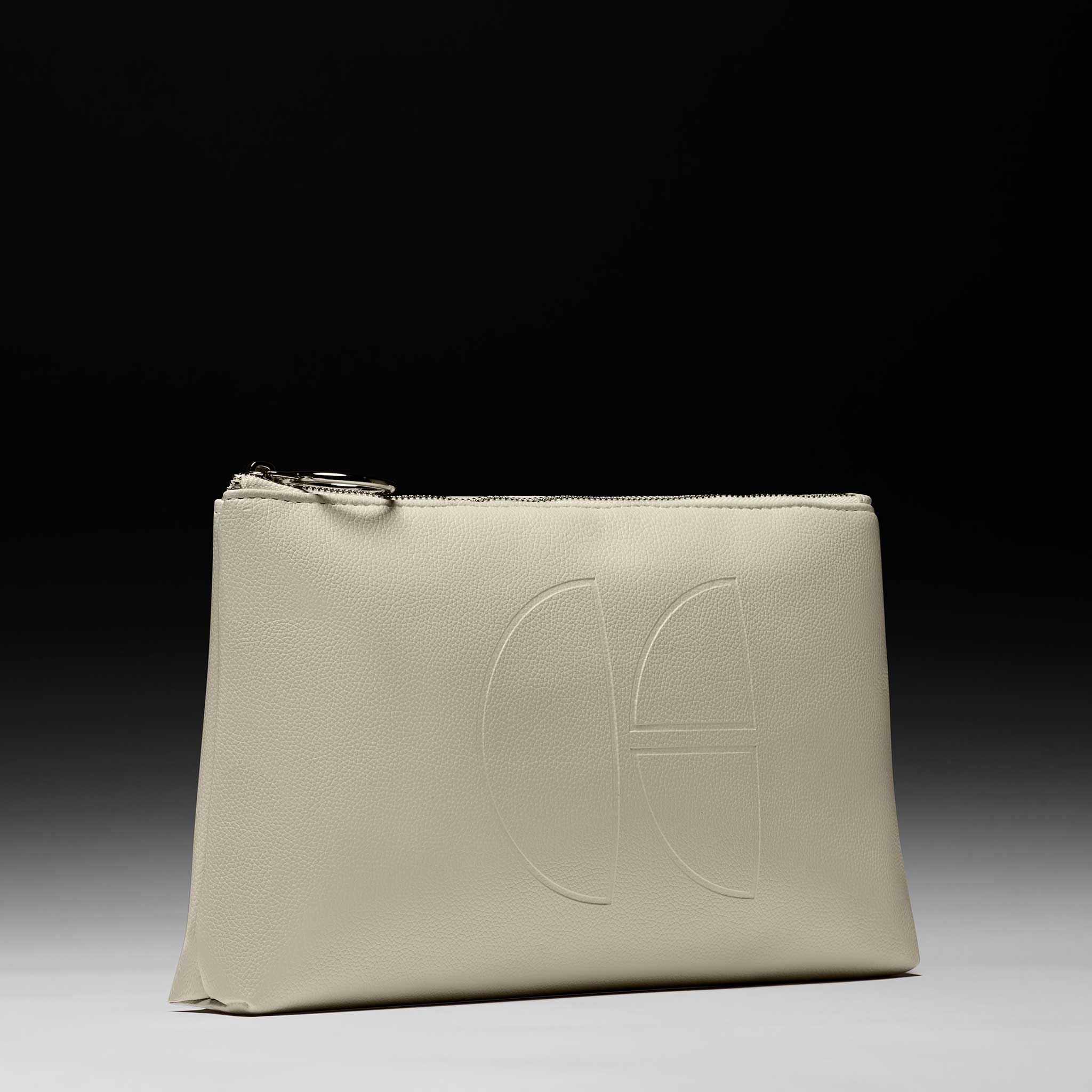 Cécred beige vegan leather travel pouch with embossed logo on gradient backdrop