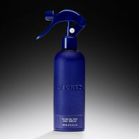Blue detangling spray bottle with 'Declared' branding on a gradient background