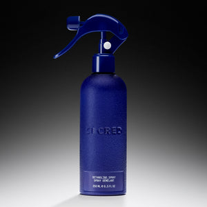 Blue detangling spray bottle with 'Declared' branding on a gradient background