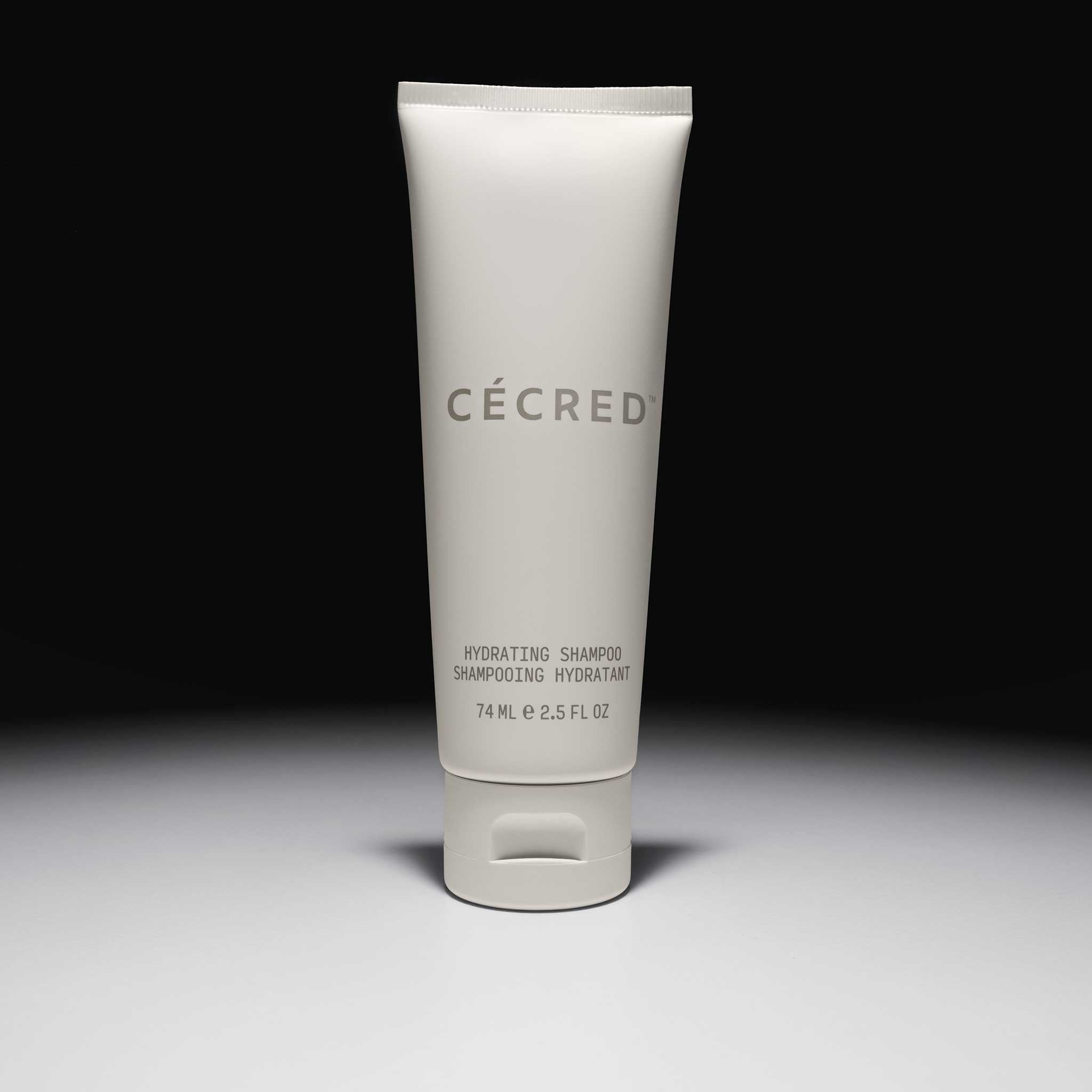 Cécred Hydrating Shampoo travel size 74ml tube displayed upright against a gradient grey background