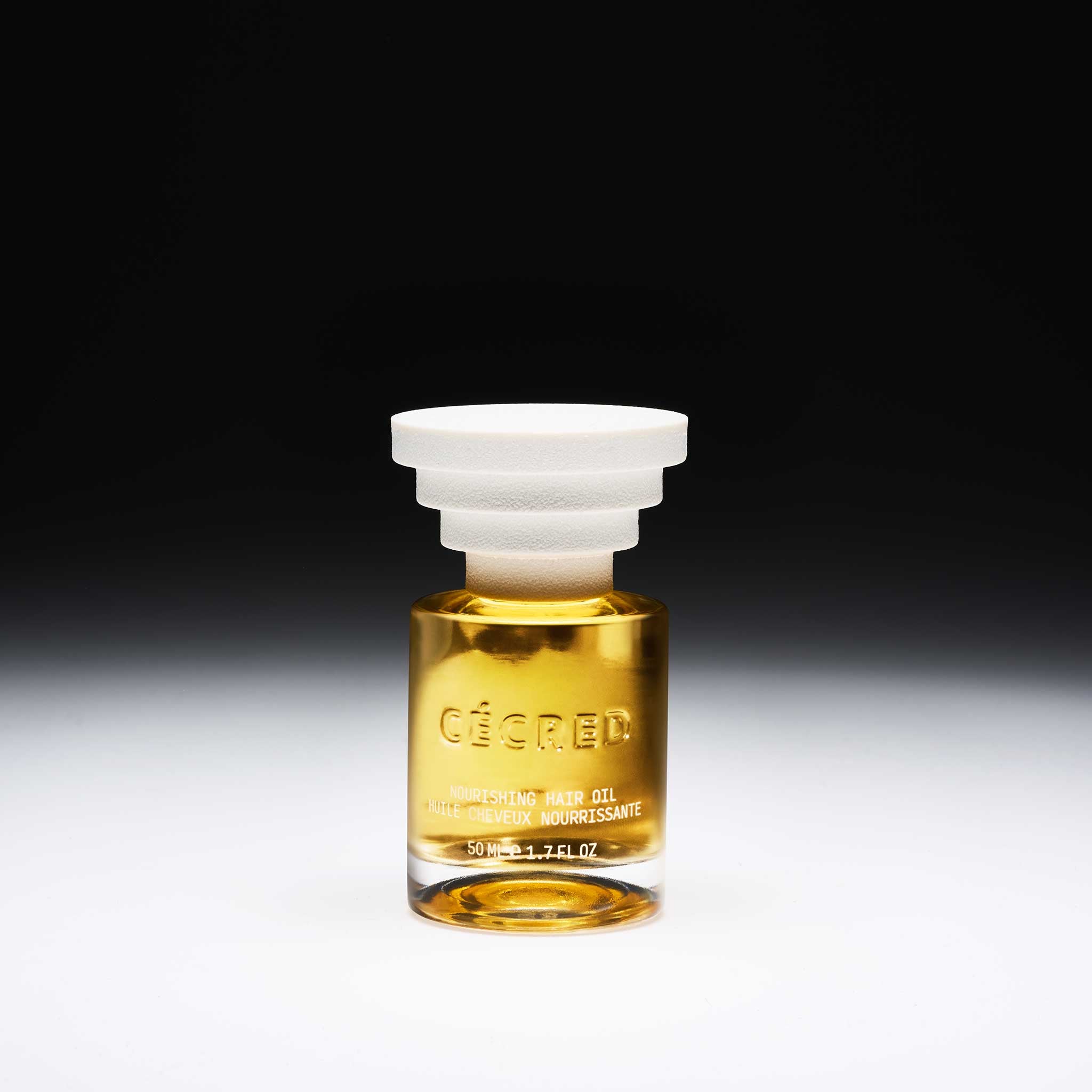 Cécred Nourishing Hair Oil 50ml amber glass bottle displayed against a gradient black-to-white background
