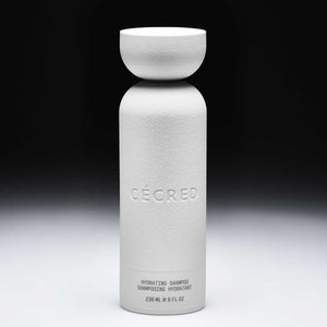 Cécred Hydrating Shampoo bottle displayed upright on a gradient black-to-white background.